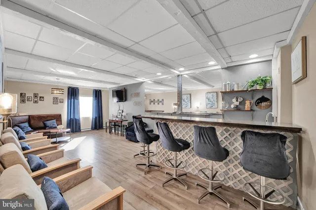 a kitchen with stainless steel appliances granite countertop a stove a sink dishwasher and cabinets with wooden floor