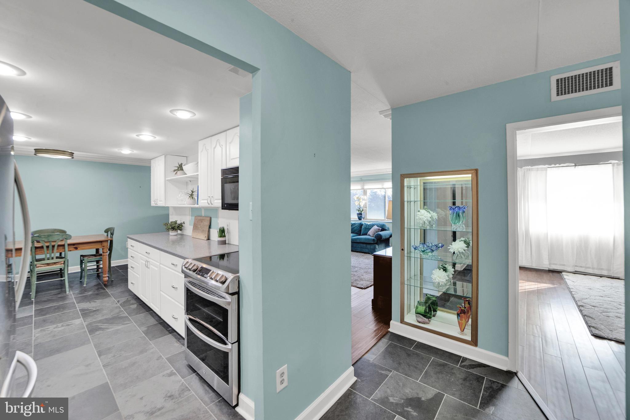 860 Lower Ferry Road, Unit 5P Ewing, NJ 08628 - Photo 7 of 29 a large kitchen with stainless steel appliances granite countertop a refrigerator and a sink