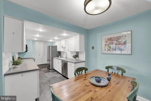 a kitchen with a table and chairs in it
