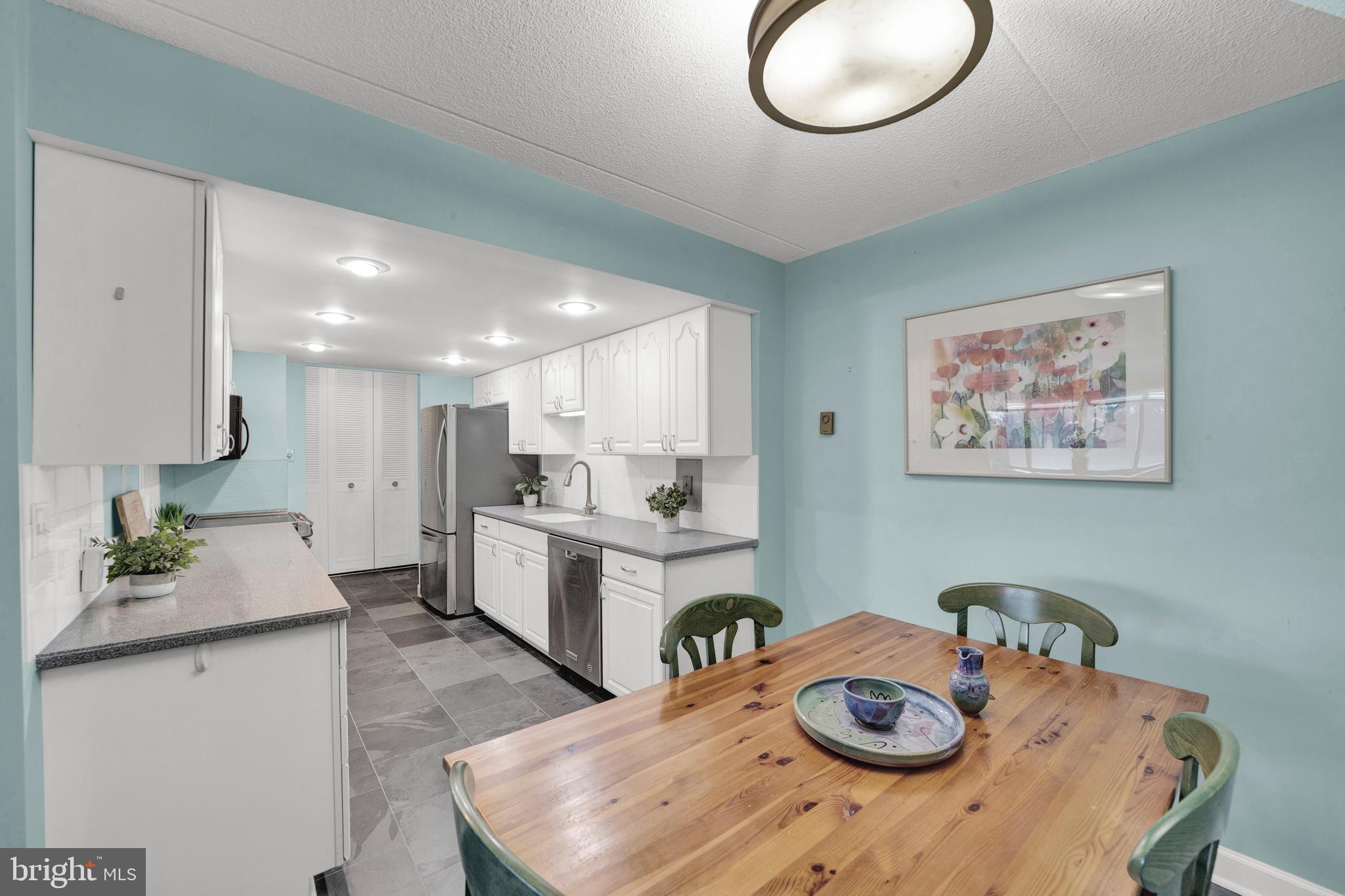 860 Lower Ferry Road, Unit 5P Ewing, NJ 08628 - Photo 8 of 29 a kitchen with a table and chairs in it