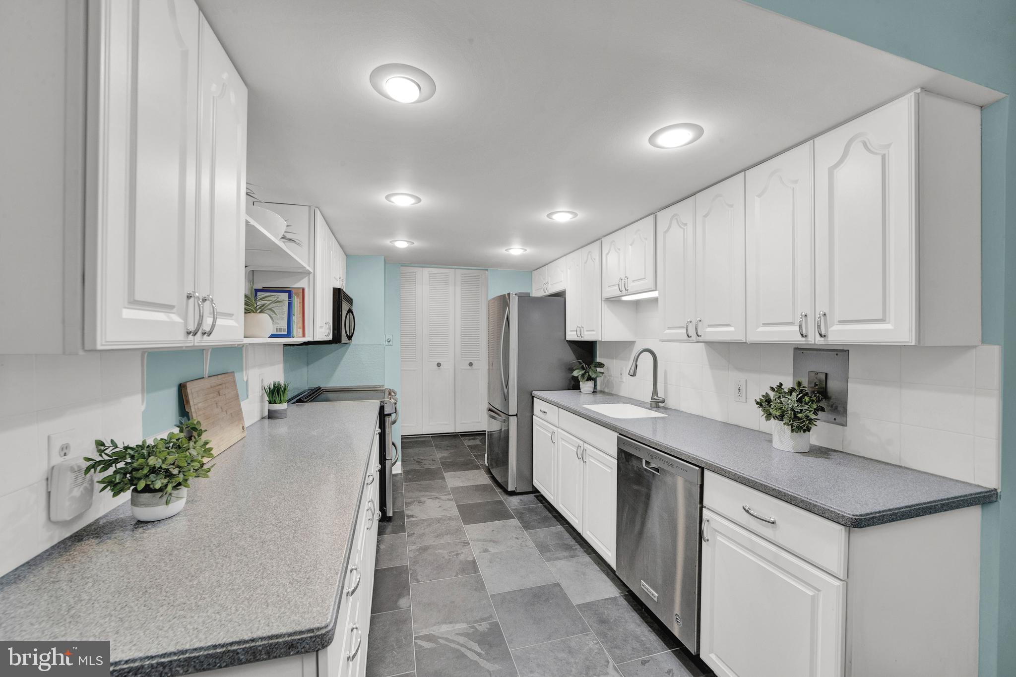 860 Lower Ferry Road, Unit 5P Ewing, NJ 08628 - Photo 10 of 29 a kitchen with white cabinets sink and white appliances