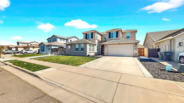 a view of multiple houses with a street