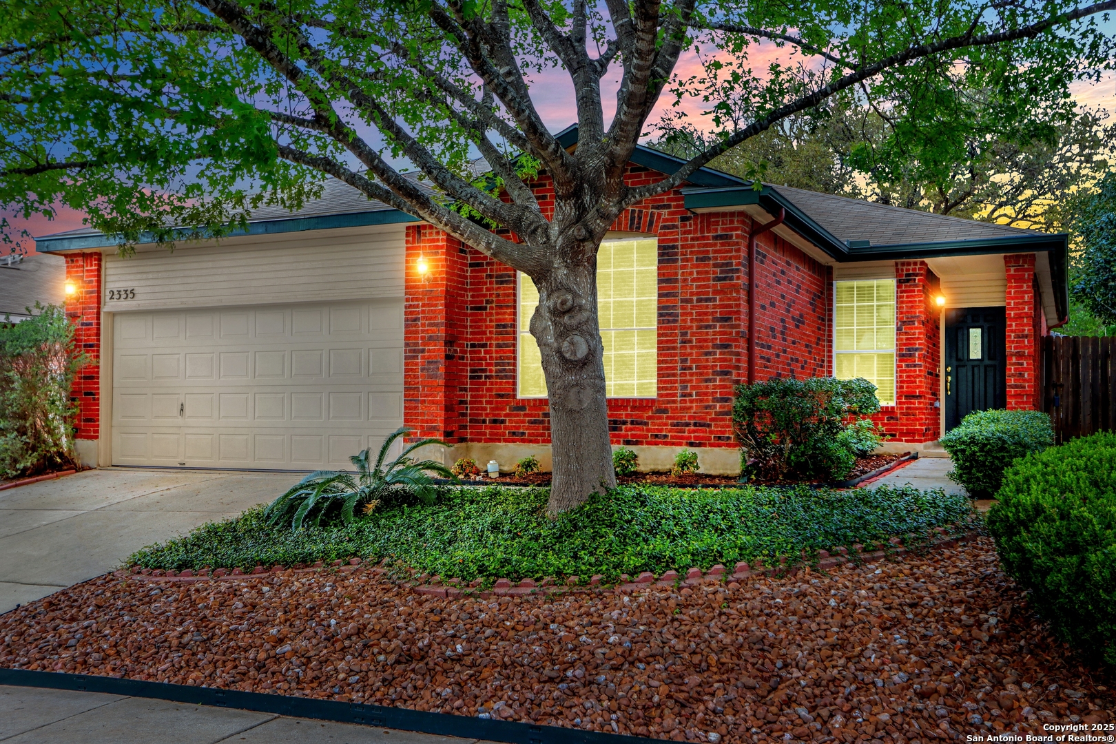 a front view of house with a garden