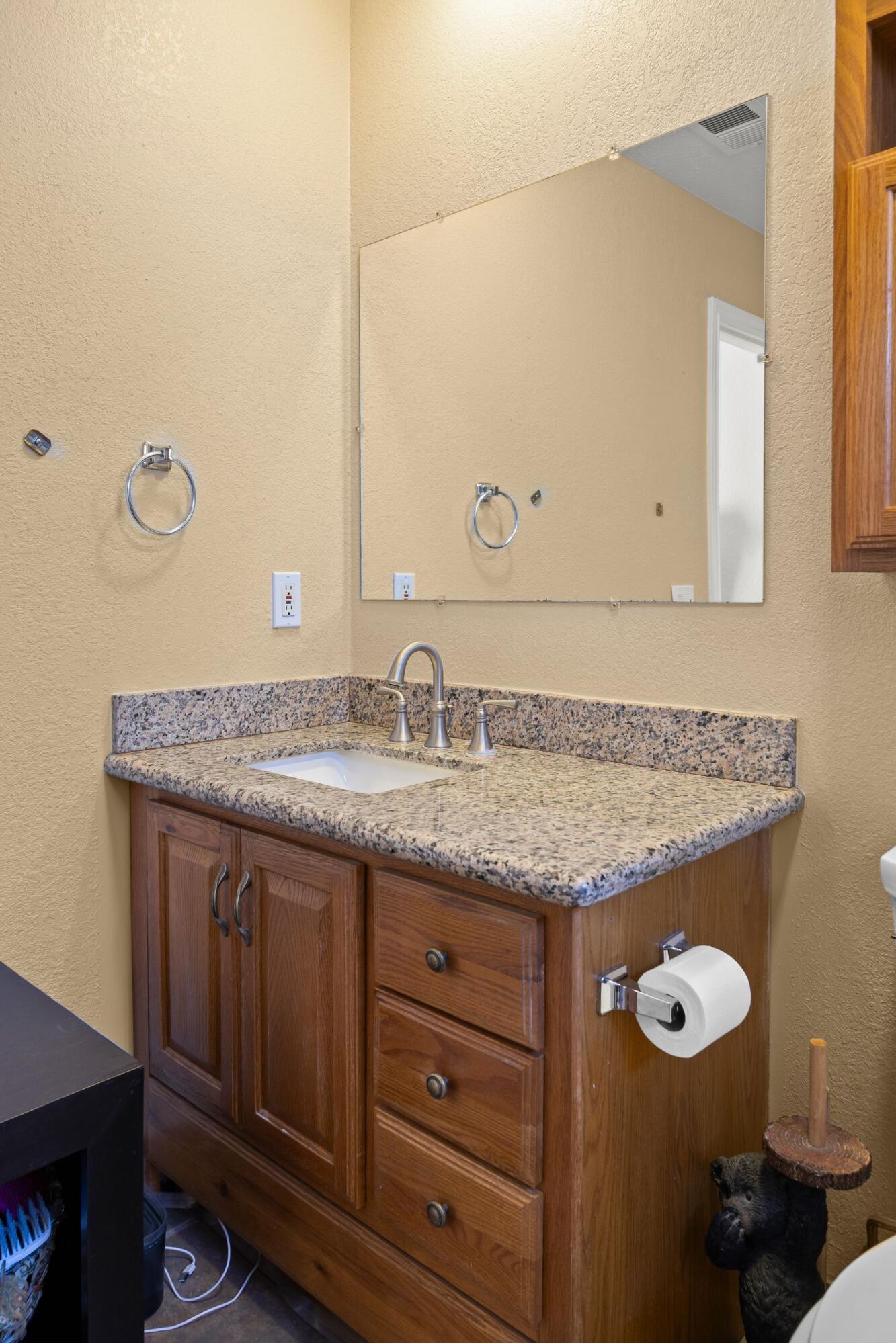 354 West Prospect Street Ventura, CA 93001 - Photo 21 of 41 a bathroom with a granite countertop sink and a mirror