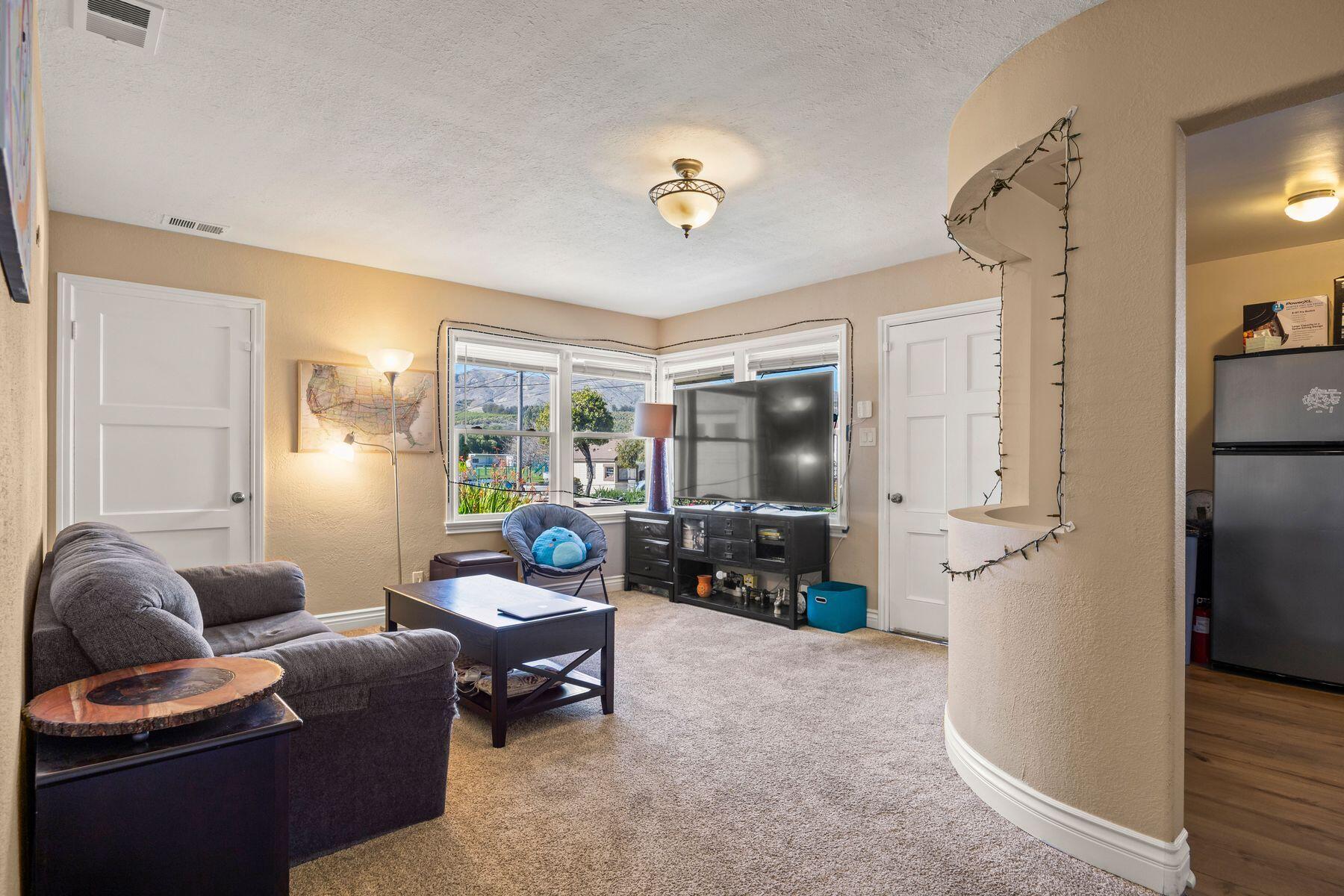 354 West Prospect Street Ventura, CA 93001 - Photo 3 of 41 a living room with furniture a large window and a chandelier