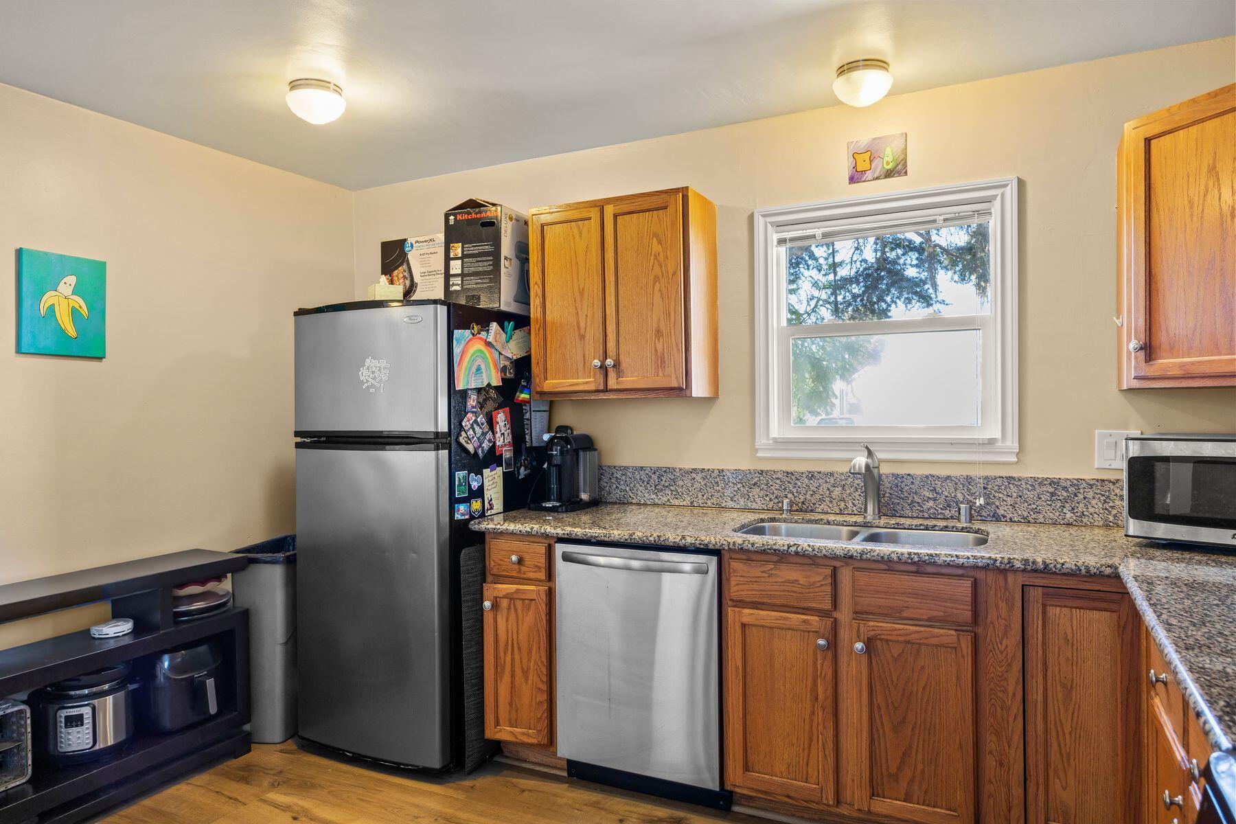354 West Prospect Street Ventura, CA 93001 - Photo 9 of 41 a kitchen with stainless steel appliances granite countertop a refrigerator a sink a stove a counter space and a window