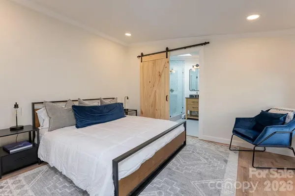 a bed room with a bed and chair