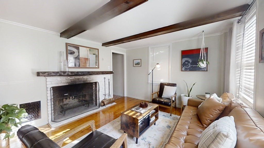 5 Pleasant Street Amesbury, MA 01913 - Photo 17 of 36 a living room with furniture a fireplace and a large window