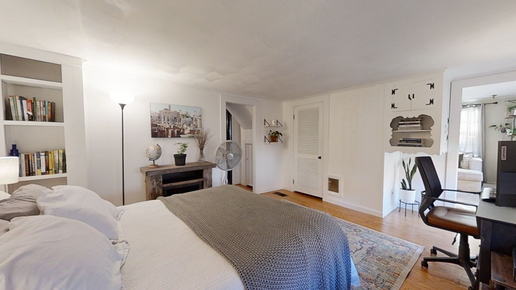 5 Pleasant Street Amesbury, MA 01913 - Photo 24 of 36 a bedroom with a bed and a chair in it