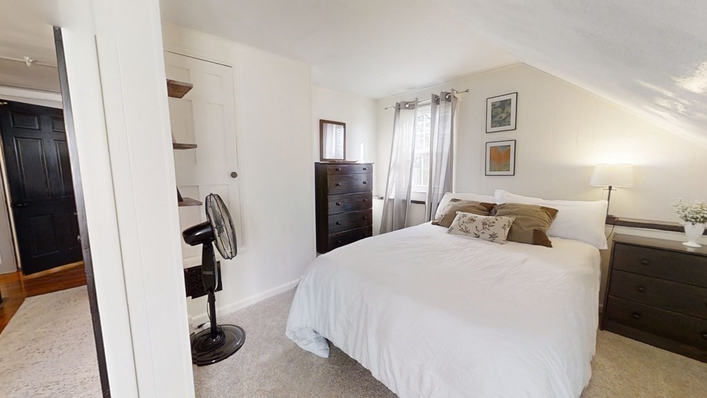 5 Pleasant Street Amesbury, MA 01913 - Photo 29 of 36 a bedroom with a bed and a refrigerator