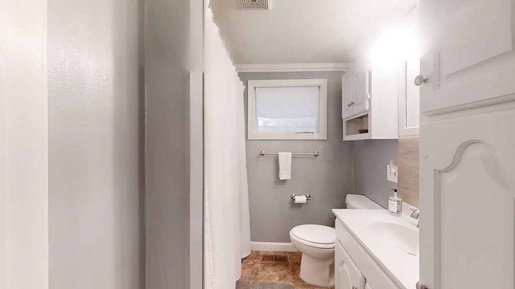 5 Pleasant Street Amesbury, MA 01913 - Photo 32 of 36 a white toilet sitting next to a bathroom sink