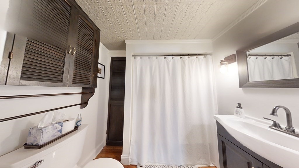 5 Pleasant Street Amesbury, MA 01913 - Photo 33 of 36 a bathroom with a sink and a mirror