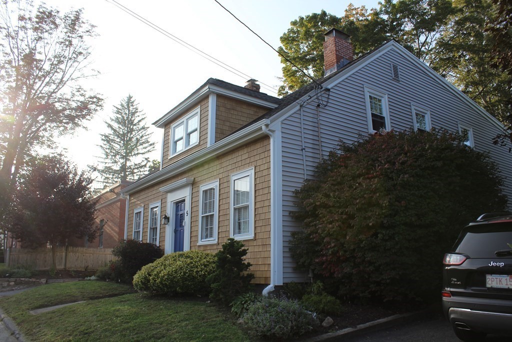5 Pleasant Street Amesbury, MA 01913 - Photo 5 of 36 a front view of a house with garden