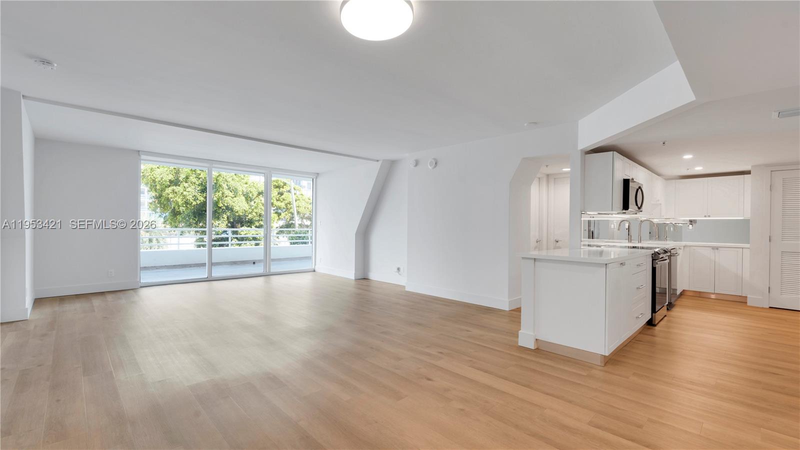 555 Northeast 34th Street, Unit 705 Miami, FL 33137 - Photo 1 of 28 a view of large kitchen with wooden floor and windows