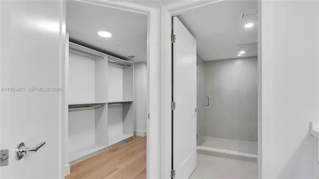 a bathroom with a shower and a glass door