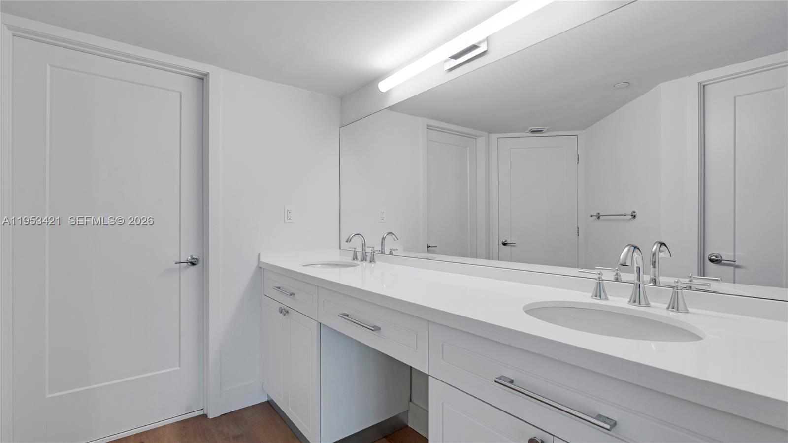 555 Northeast 34th Street, Unit 705 Miami, FL 33137 - Photo 13 of 28 a bathroom with a sink and a mirror