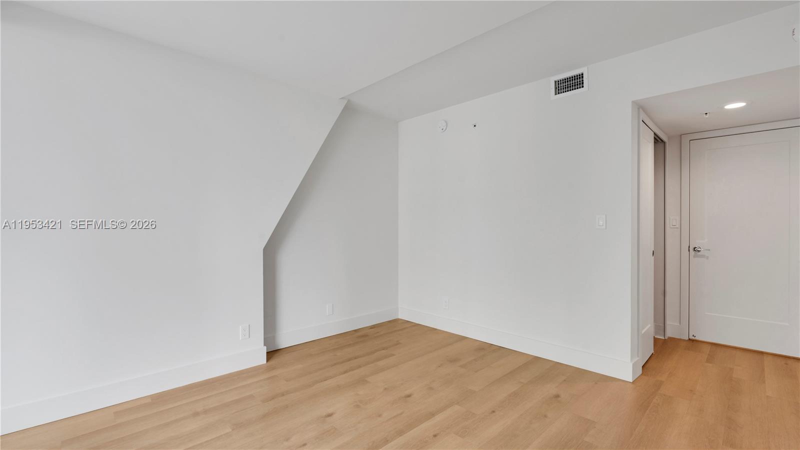 555 Northeast 34th Street, Unit 705 Miami, FL 33137 - Photo 17 of 28 a view of empty room with wooden floor