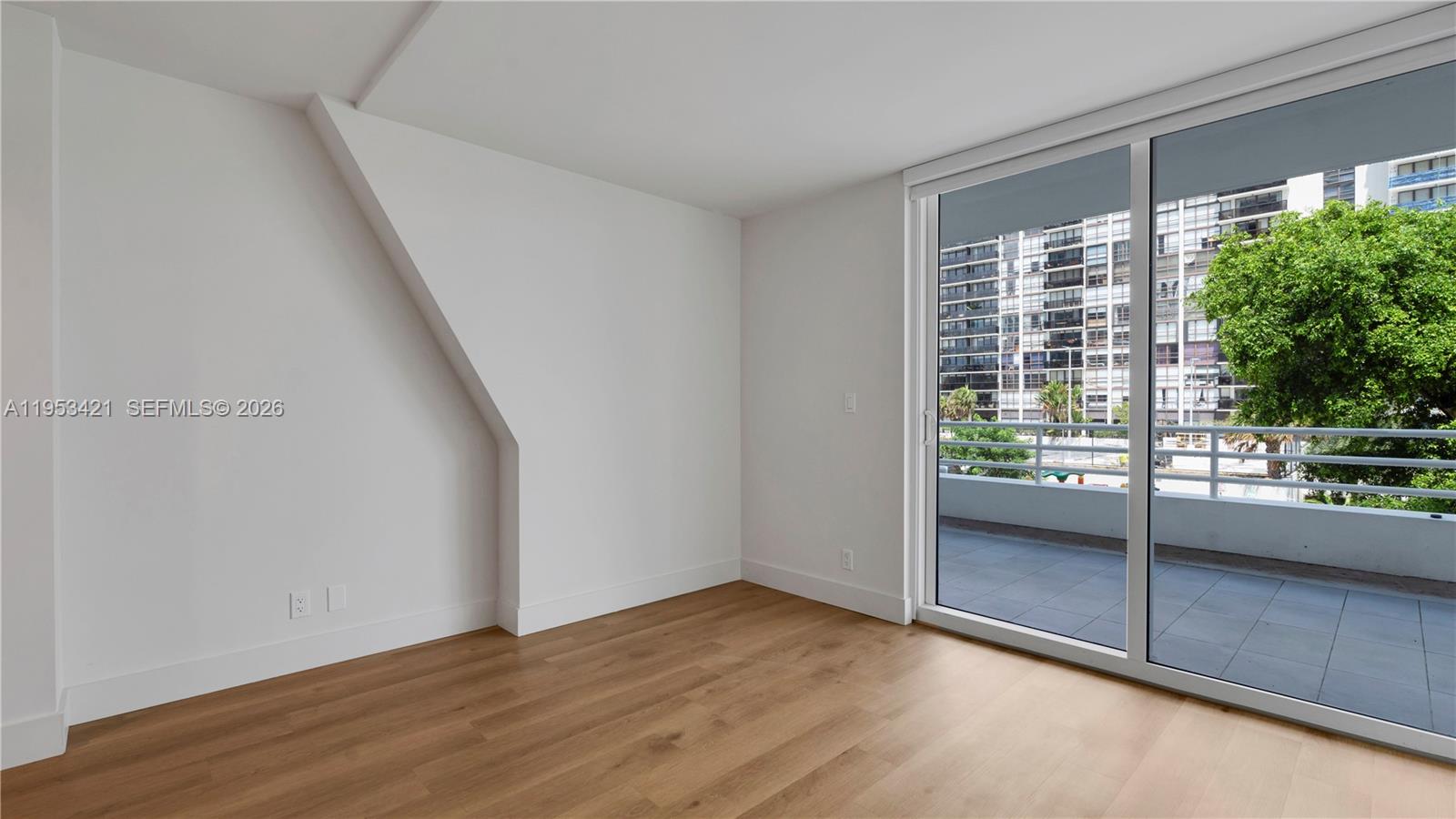 555 Northeast 34th Street, Unit 705 Miami, FL 33137 - Photo 18 of 28 an empty room with wooden floor and windows