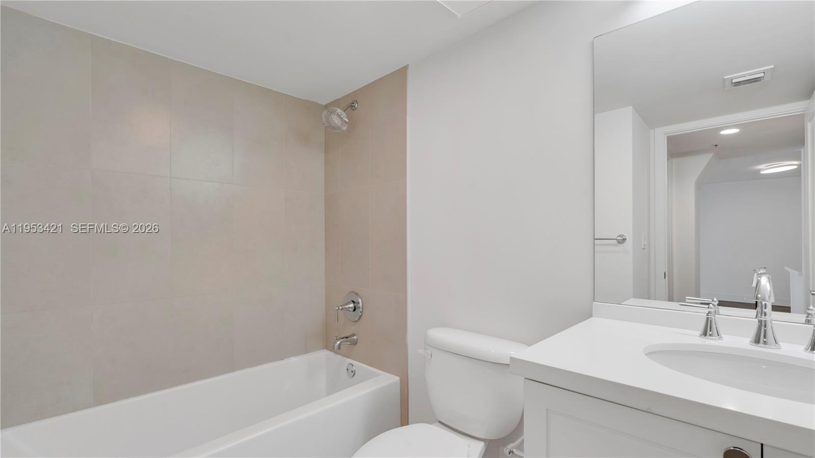 555 Northeast 34th Street, Unit 705 Miami, FL 33137 - Photo 21 of 28 a bathroom with a sink and a mirror