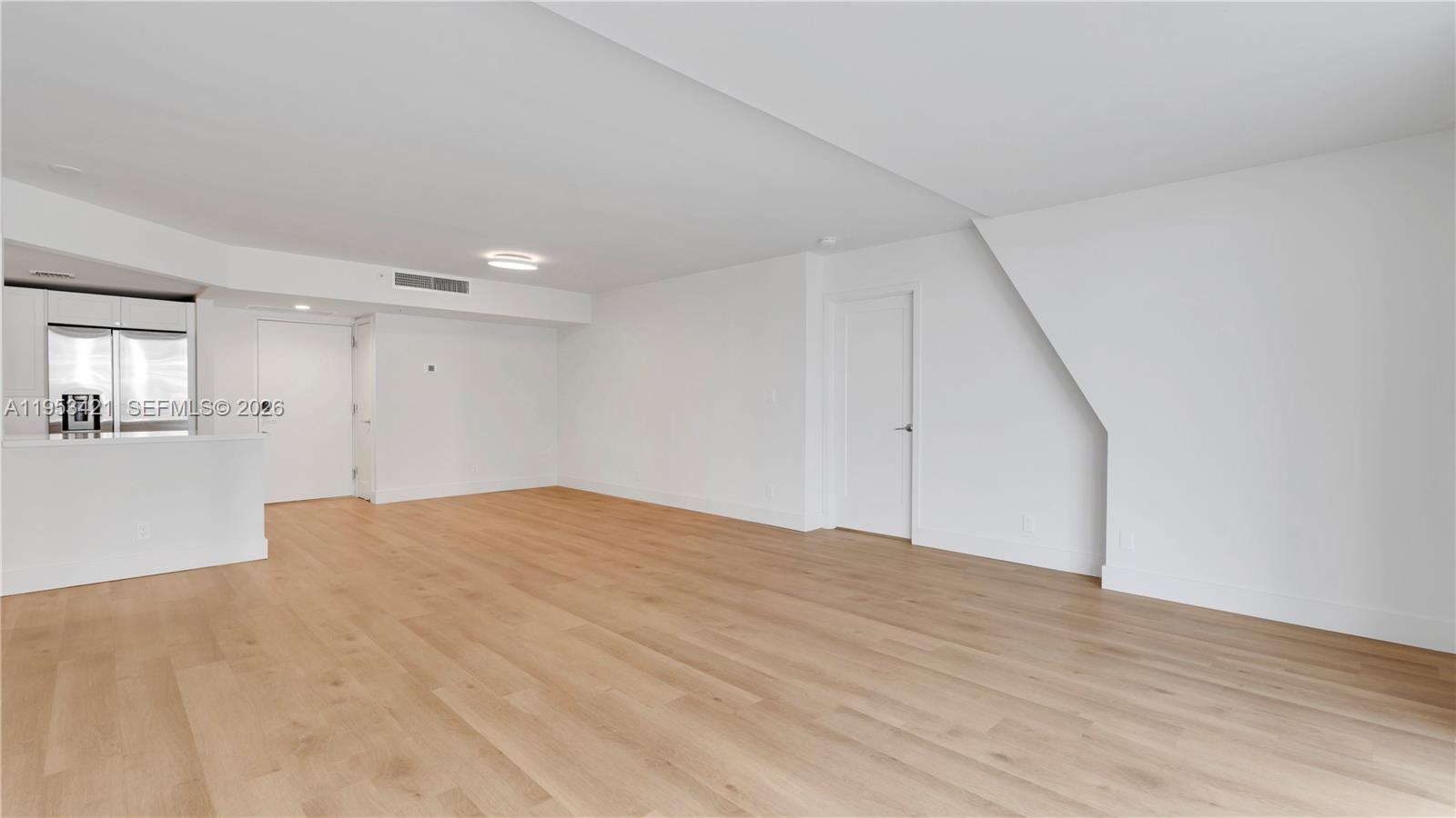 555 Northeast 34th Street, Unit 705 Miami, FL 33137 - Photo 7 of 28 a view of an empty room with wooden floor