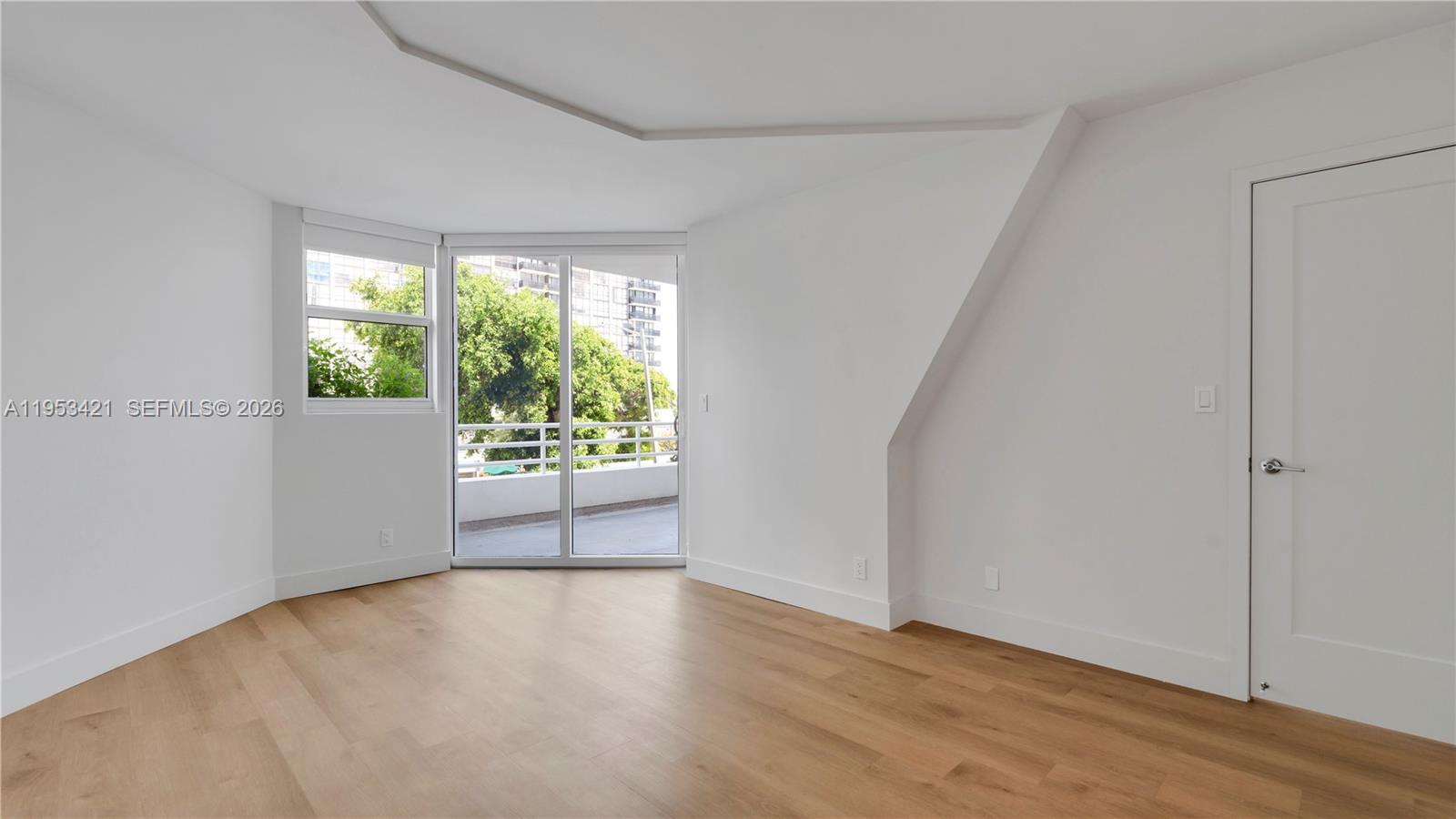 555 Northeast 34th Street, Unit 705 Miami, FL 33137 - Photo 8 of 28 a view of an empty room with wooden floor and a window