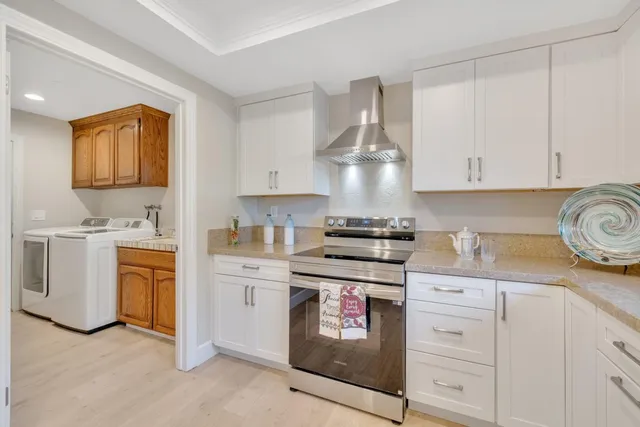 a spacious bedroom with a large bed and a chandelier