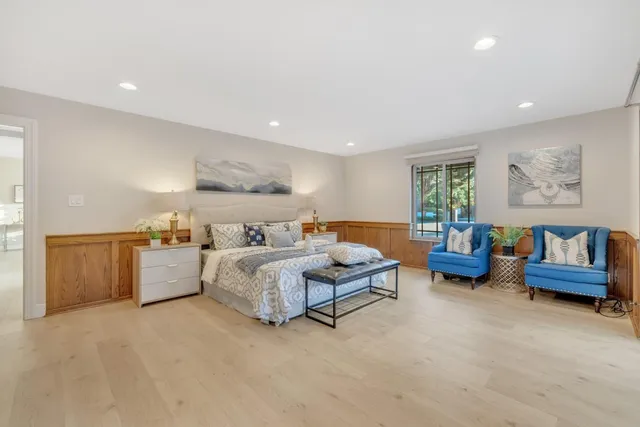 a bathroom with a tub a mirror and a shower