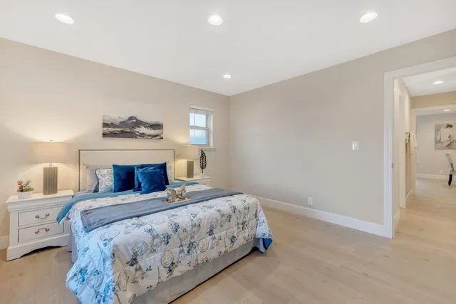 a kitchen with stainless steel appliances granite countertop a sink and cabinets with wooden floor