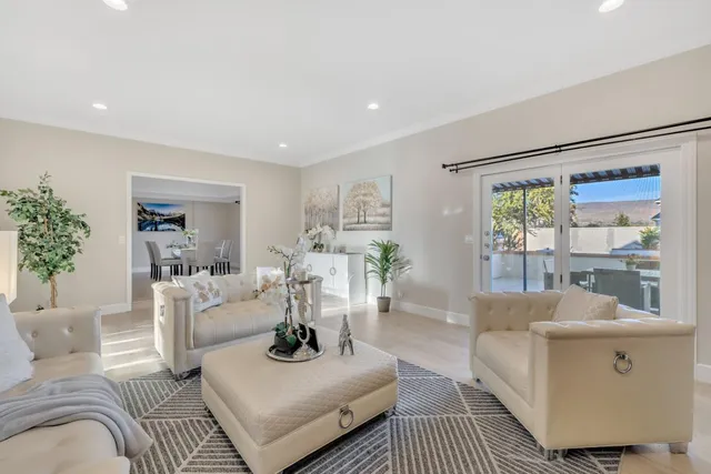 a hall with kitchen island white cabinets and sink