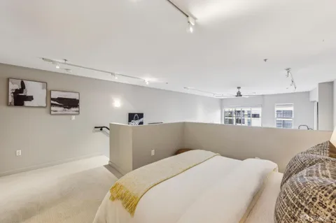 a bedroom with bed and a night stand