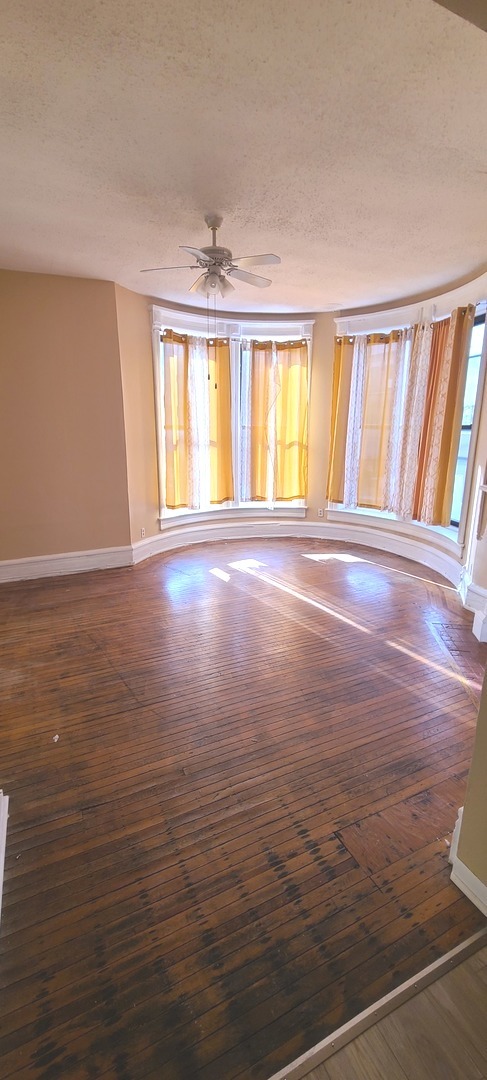1332 West 18th Street, Unit 2F Chicago, IL 60608 - Photo 2 of 11 wooden floor in an empty room with a window