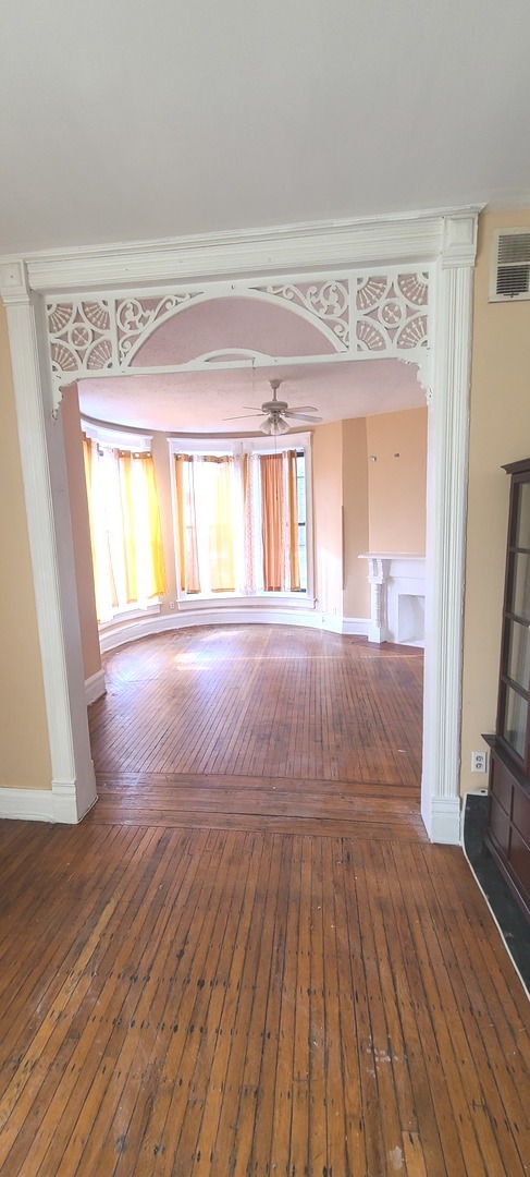 1332 West 18th Street, Unit 2F Chicago, IL 60608 - Photo 7 of 11 a view of an empty room with wooden floor and a window