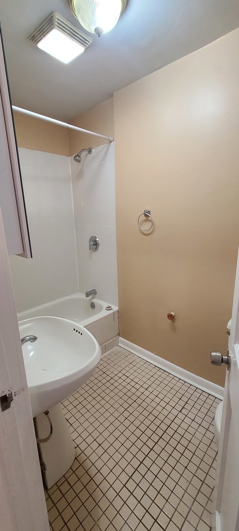 1332 West 18th Street, Unit 2F Chicago, IL 60608 - Photo 8 of 11 a bathroom with a sink a toilet and shower