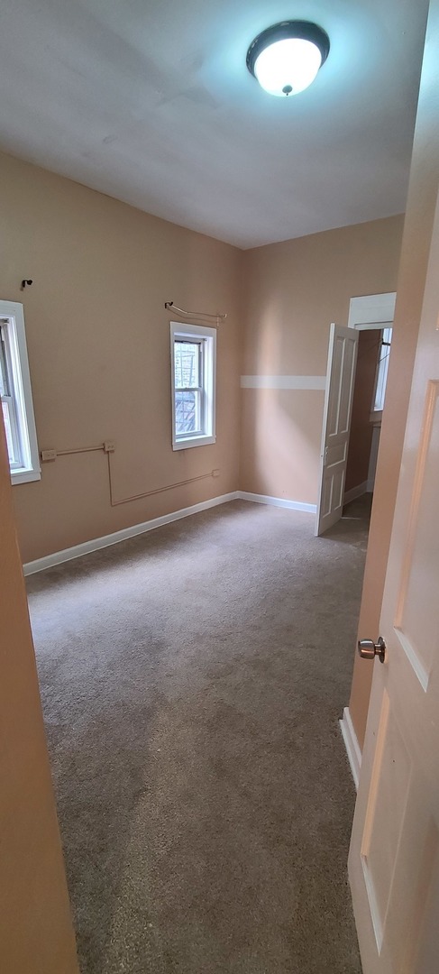 1332 West 18th Street, Unit 2F Chicago, IL 60608 - Photo 9 of 11 an empty room with windows