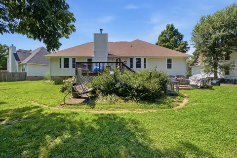 a view of a house with backyard sitting area and garden