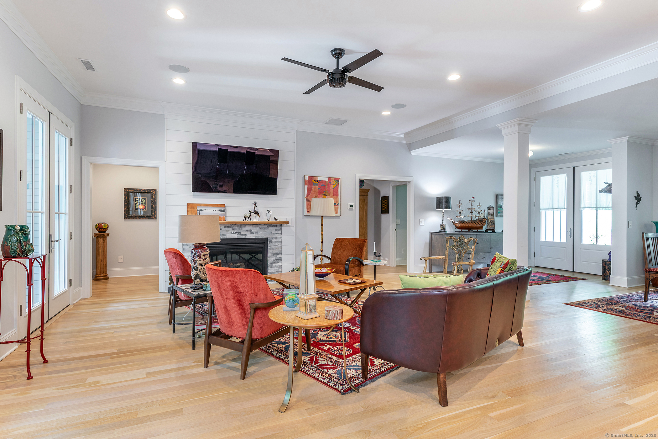 73 Long River Road Sherman, CT 06784 - Photo 11 of 31 a living room with furniture a flat screen tv and a fireplace