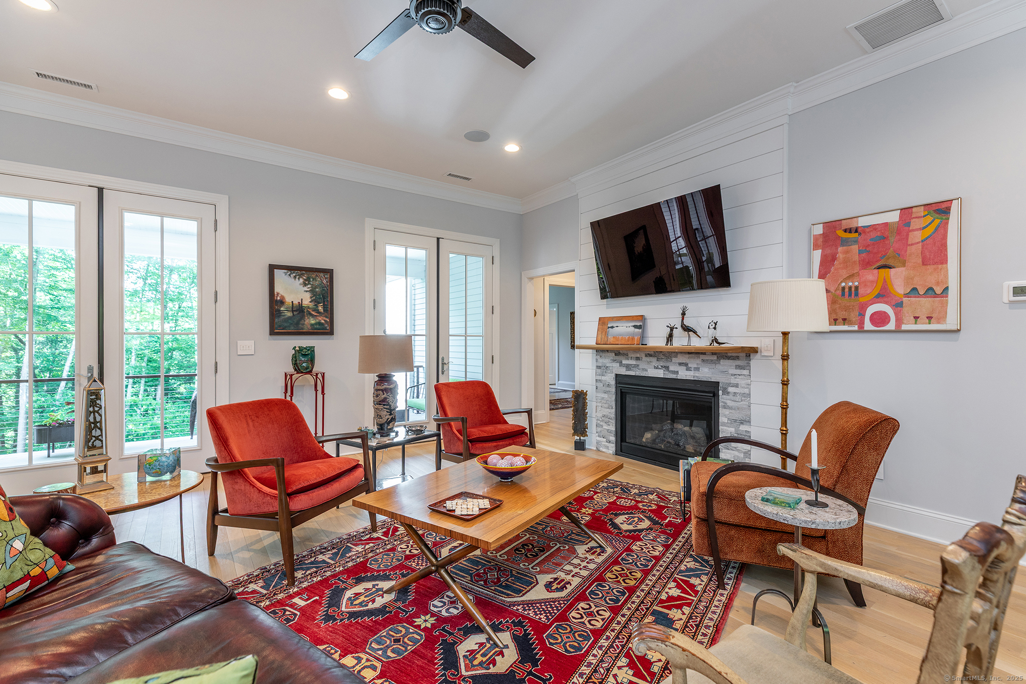 73 Long River Road Sherman, CT 06784 - Photo 12 of 31 a living room with furniture a fireplace and a flat screen tv