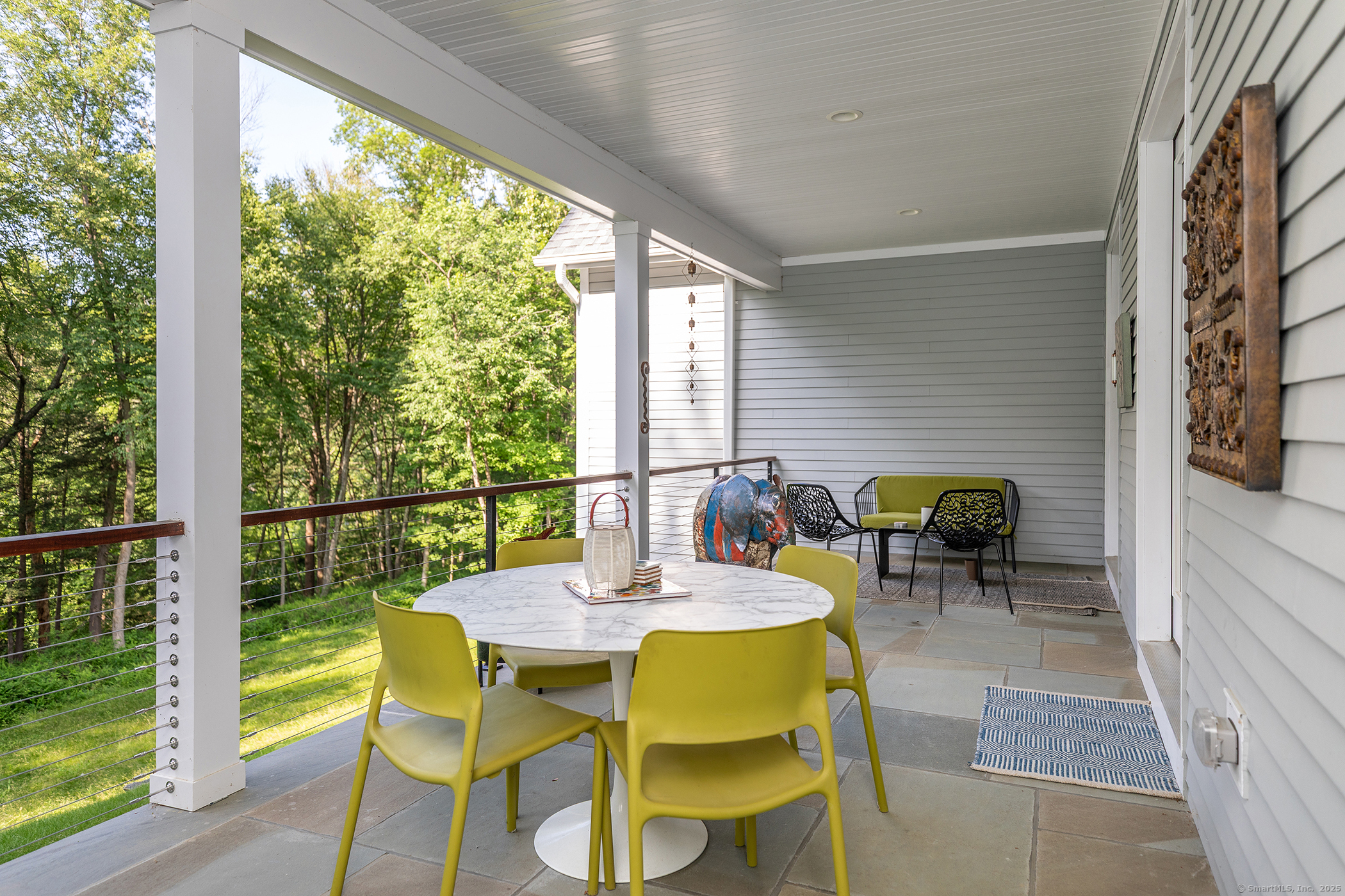 73 Long River Road Sherman, CT 06784 - Photo 14 of 31 a view of a dining table and chairs in the balcony