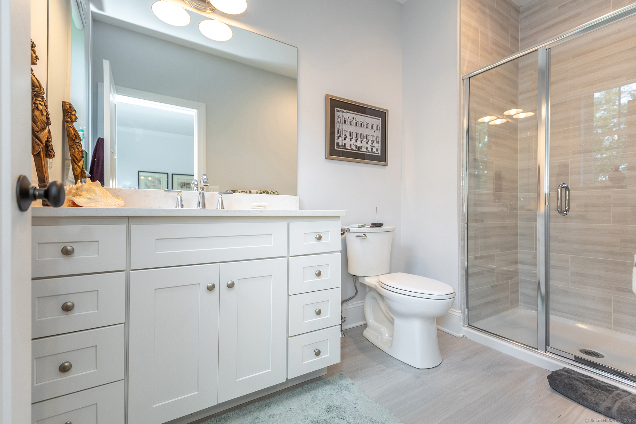 73 Long River Road Sherman, CT 06784 - Photo 24 of 31 a bathroom with a toilet a sink and glass door