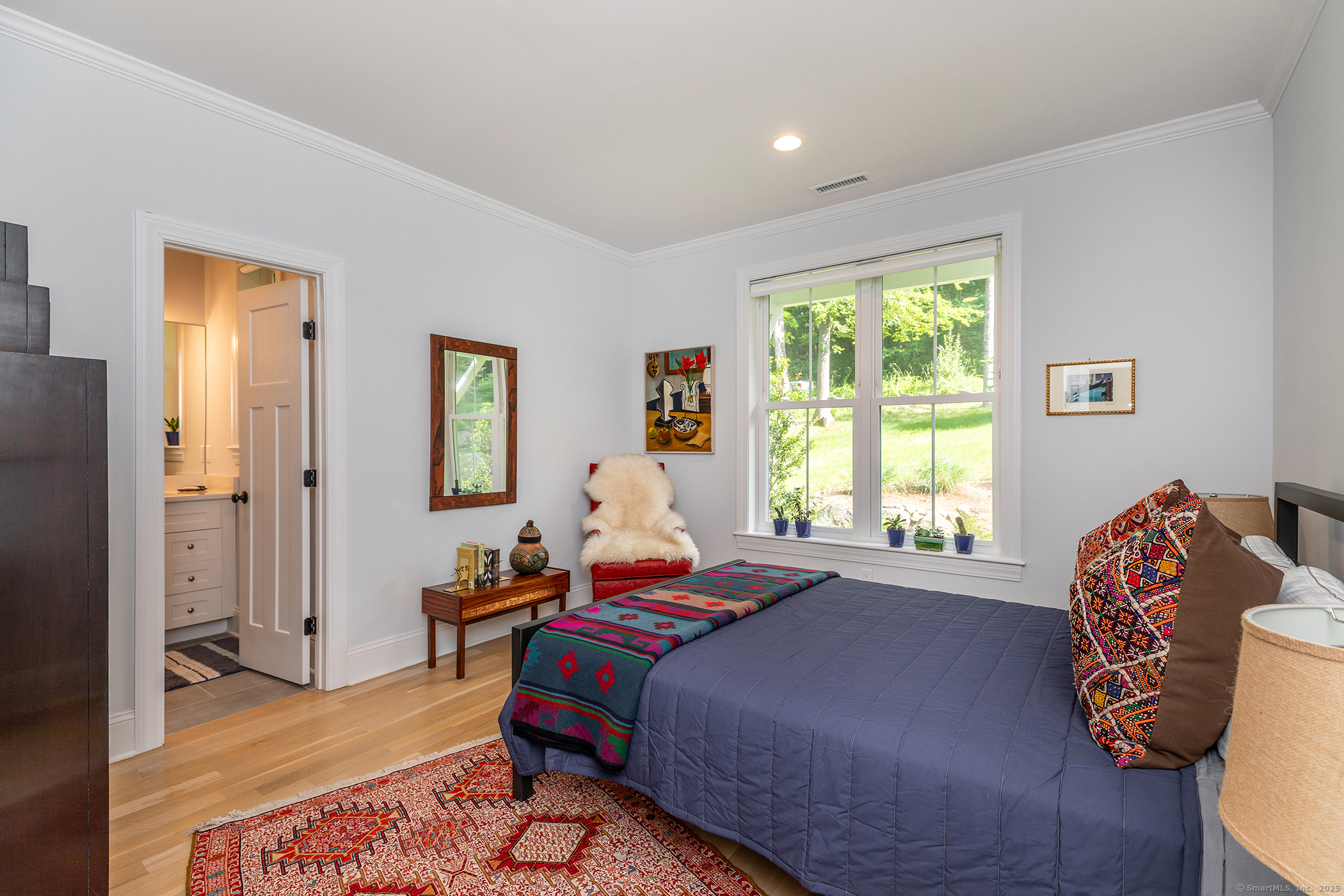 73 Long River Road Sherman, CT 06784 - Photo 25 of 31 a bedroom with a bed and wooden floor