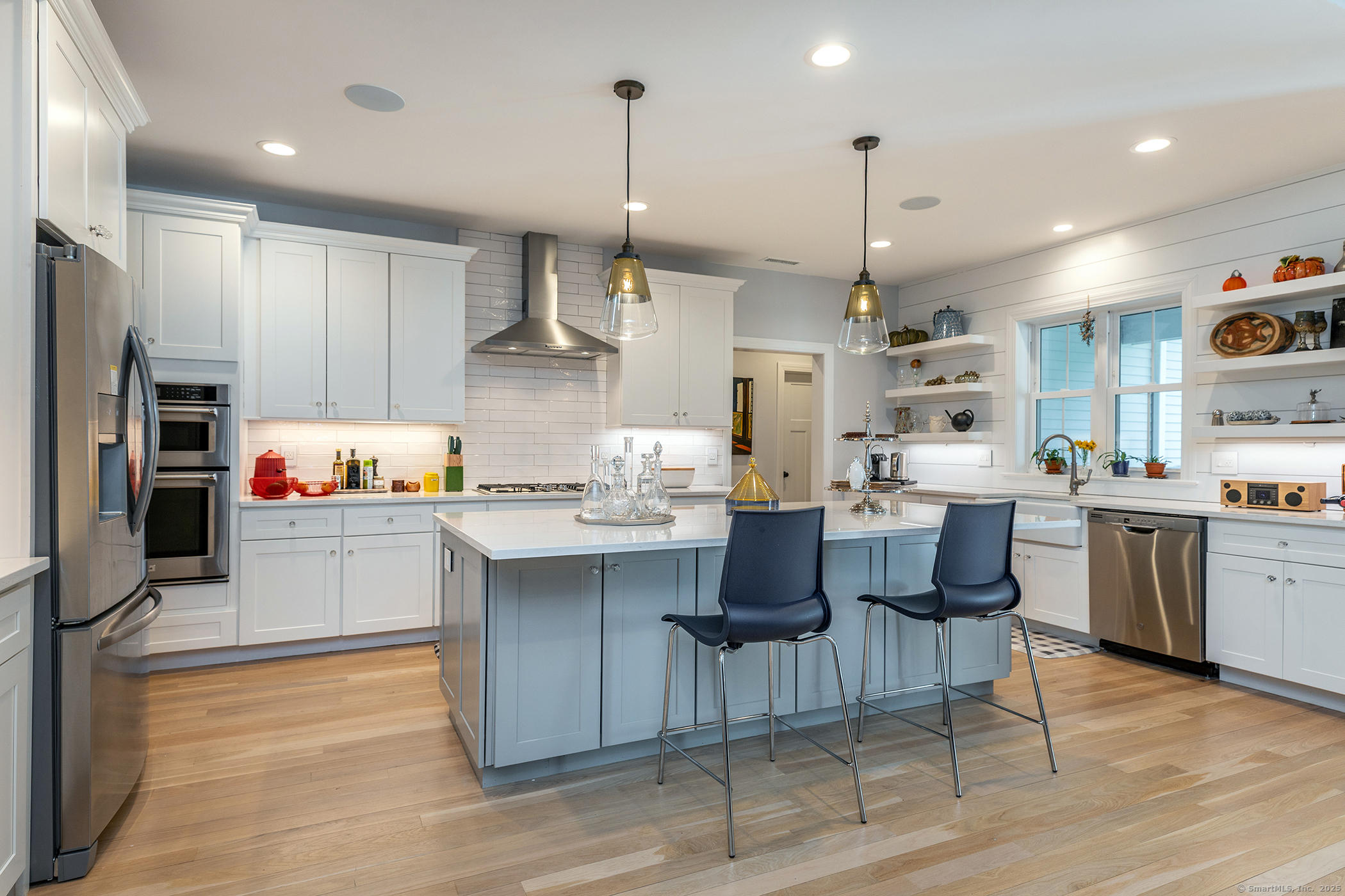 73 Long River Road Sherman, CT 06784 - Photo 5 of 31 a kitchen with stainless steel appliances granite countertop a sink dishwasher a refrigerator and a dining table with wooden floor