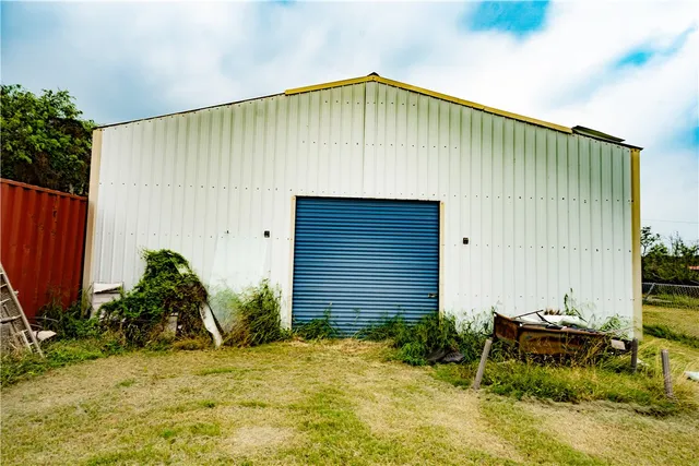 a backyard of a house with plants and trees