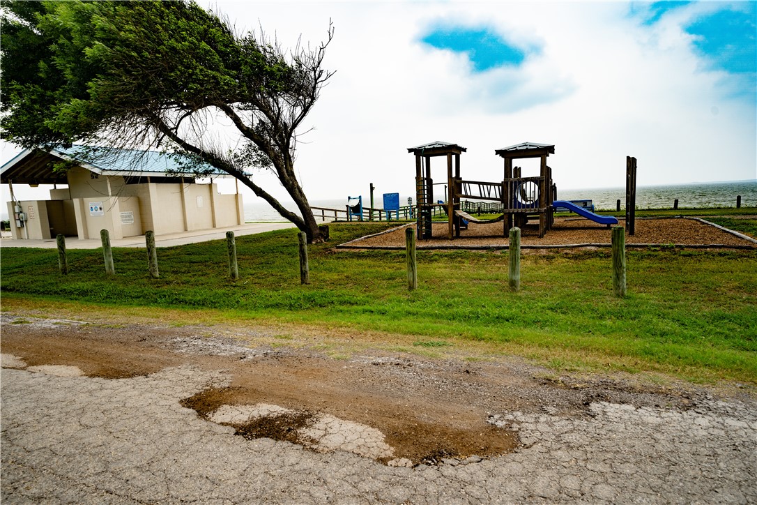 608 1st Street Bayside, TX 78340 - Photo 12 of 16 a view of a park with swings and slides