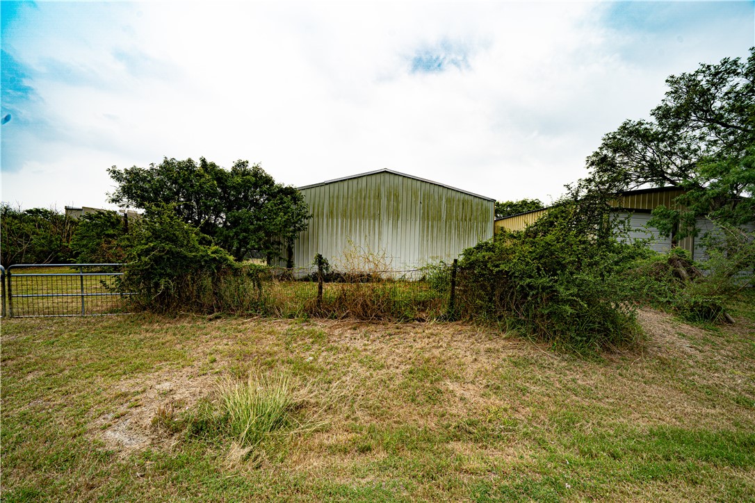 608 1st Street Bayside, TX 78340 - Photo 9 of 16 a backyard of a house with lots of green space