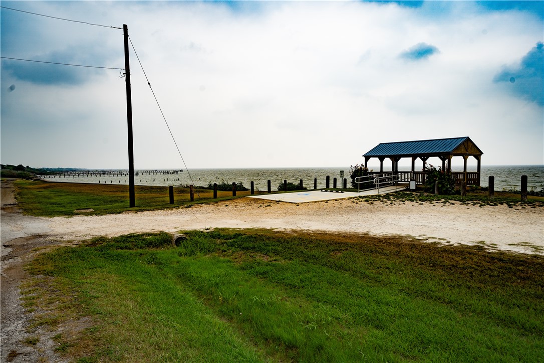 608 1st Street Bayside, TX 78340 - Photo 10 of 16 a view of a lake with a big yard and large trees