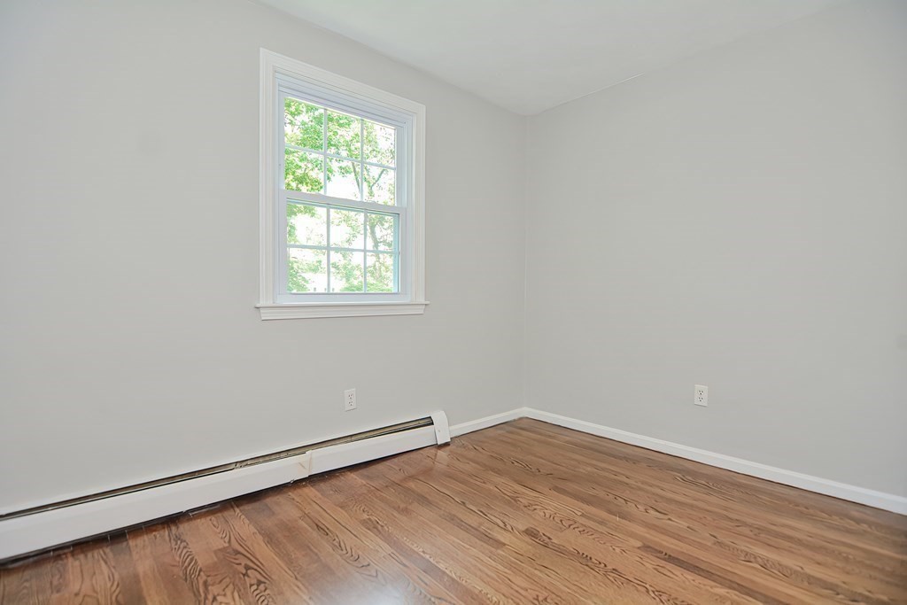 2 Labo Lane Bedford, MA 01730 - Photo 24 of 40 an empty room with wooden floor and windows