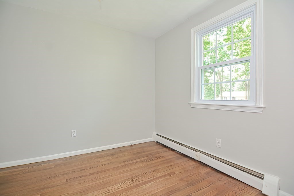 2 Labo Lane Bedford, MA 01730 - Photo 25 of 40 an empty room with wooden floor and windows
