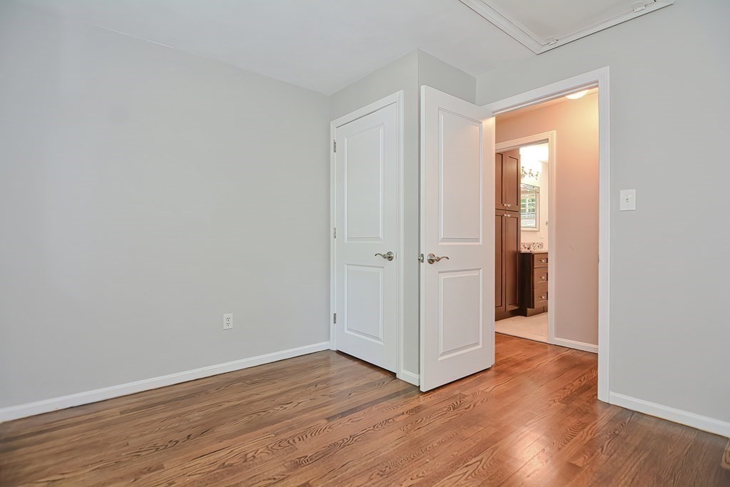 2 Labo Lane Bedford, MA 01730 - Photo 26 of 40 an empty room with wooden floor and a window