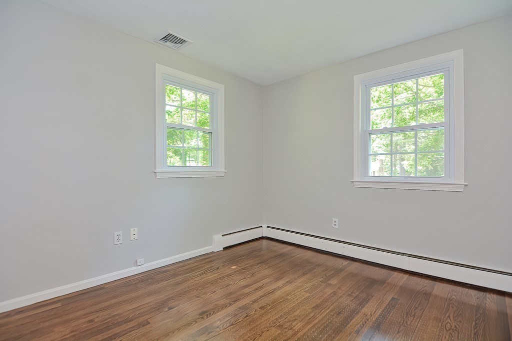 2 Labo Lane Bedford, MA 01730 - Photo 27 of 40 an empty room with wooden floor and windows
