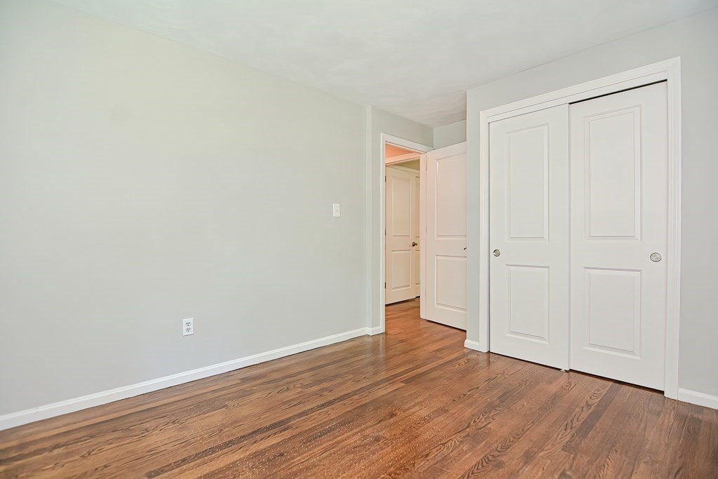 2 Labo Lane Bedford, MA 01730 - Photo 28 of 40 a view of an empty room with wooden floor